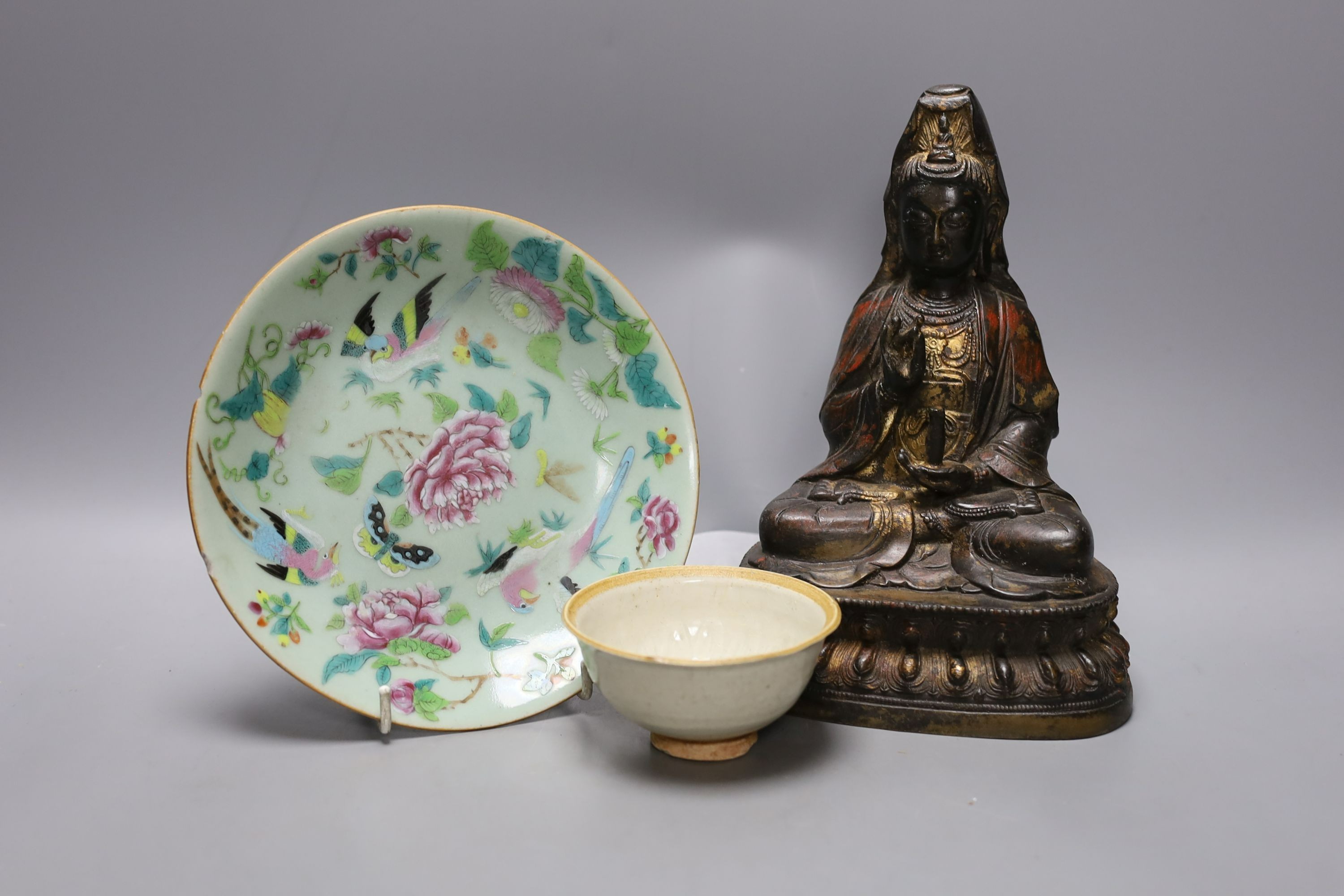 A Chinese iron alloy figure of Guanyin, 23cm tall, together with a Chinese Ding type bowl and a Chinese enamelled porcelain dish (3)